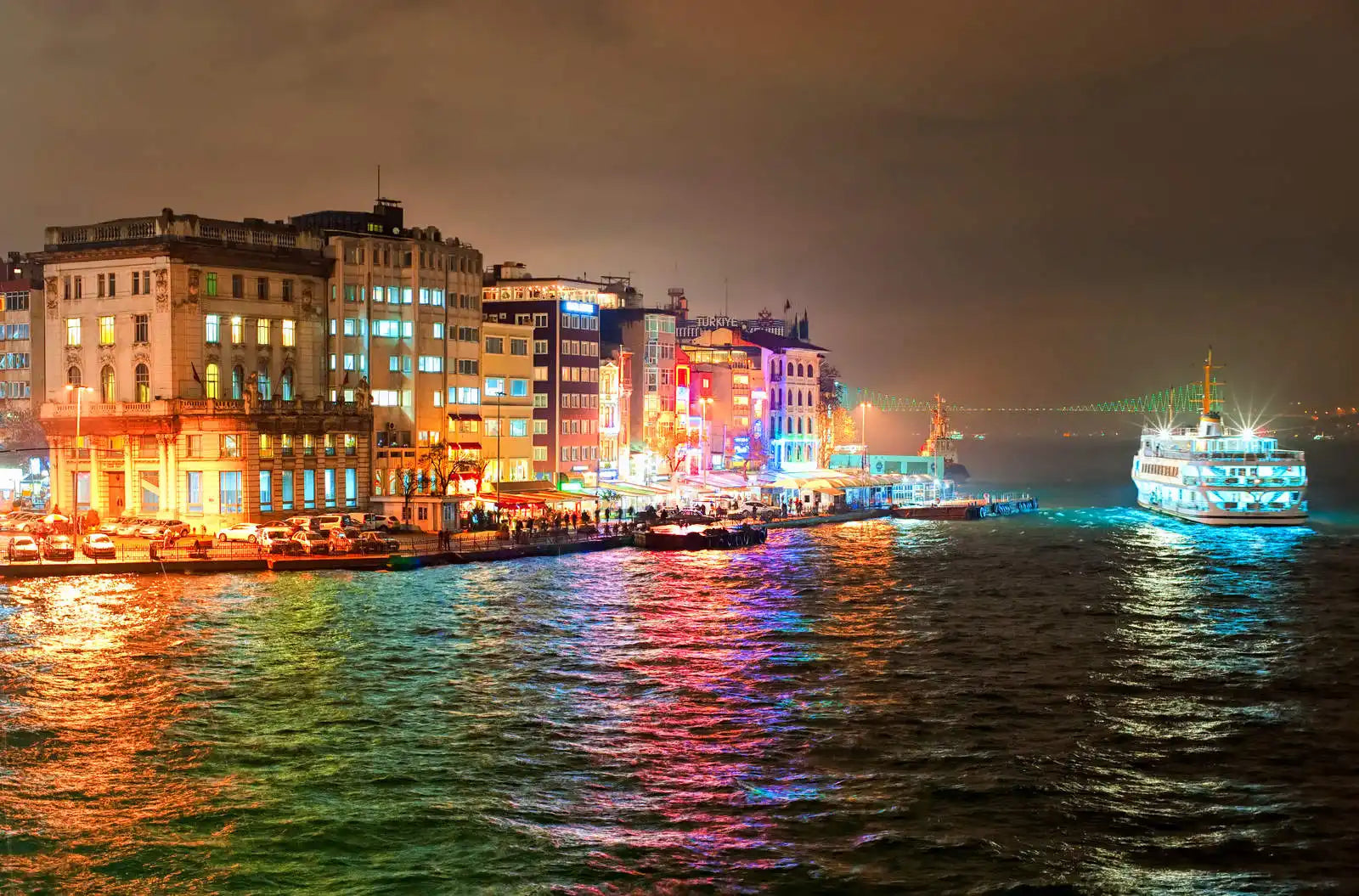 Illuminated waterfront cityscape.